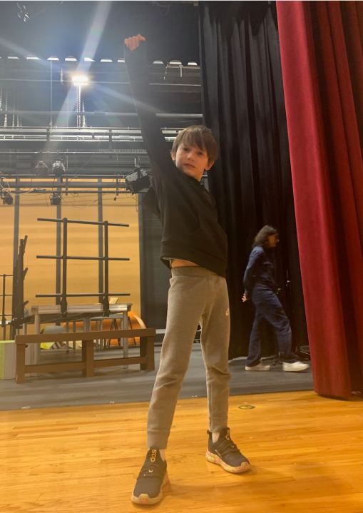 Ben DelPizzo posing onstage during rehearsal
